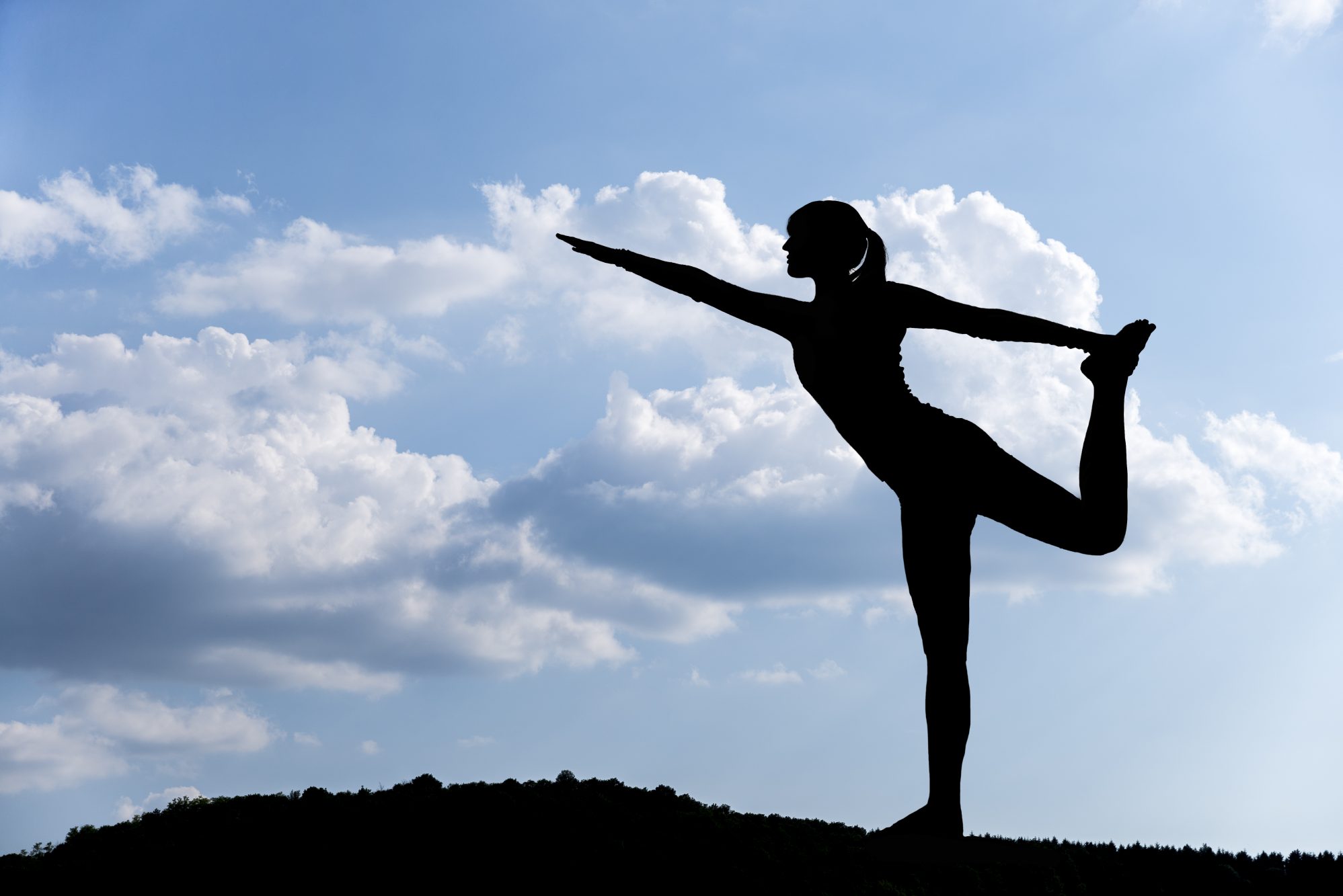 Woman doing yoga exercise outdoors