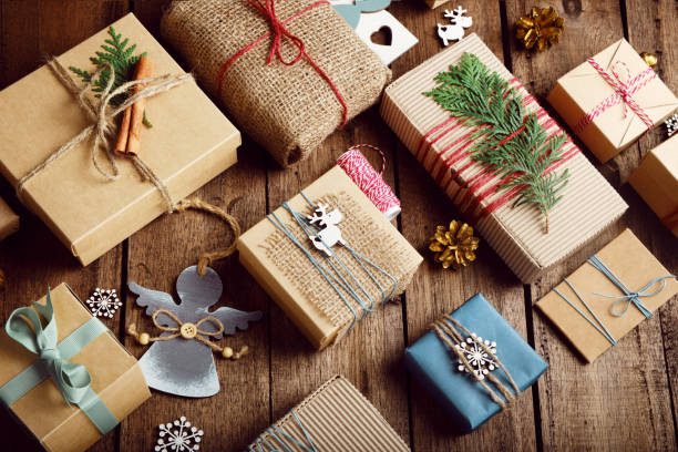 Christmas gifts on a wooden table. Ecological packaging. Zero waste holidays.
